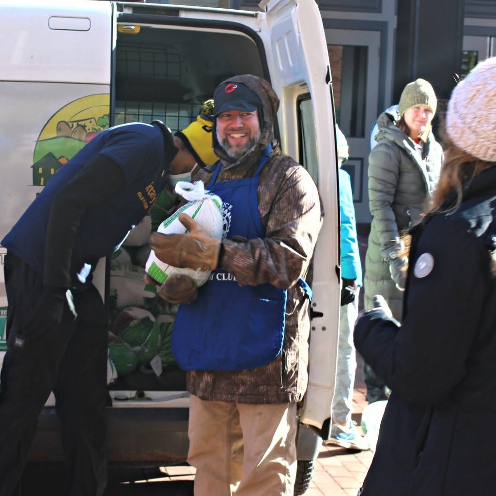 Photograph of someone holding a turkey for Feeding Champlain Valley's Turkey Trot fundraiser to provide Thanksgiving meals in Vermont.